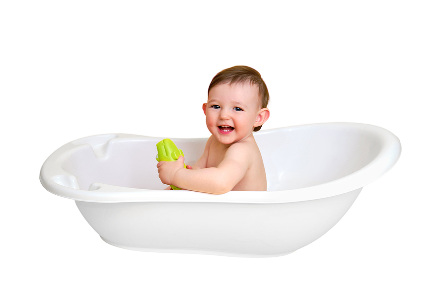 a green crocodile toy in a bathtub
