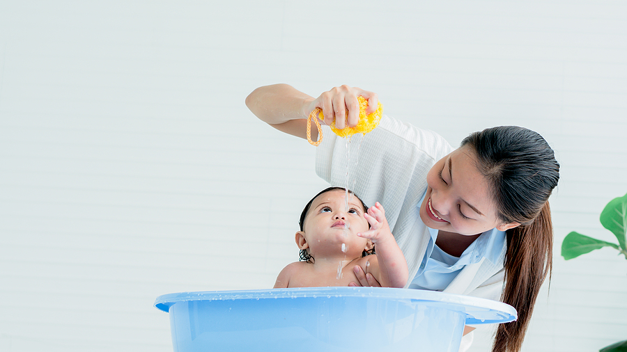 Asian mother Bathing her 7-month-old daughter