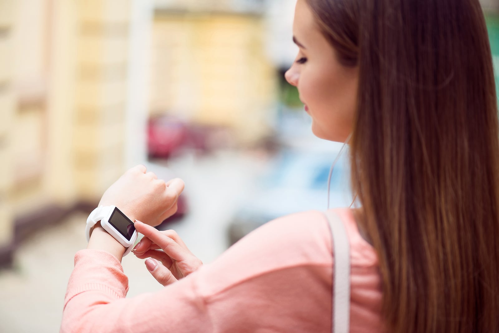 woman looking at smartwatch