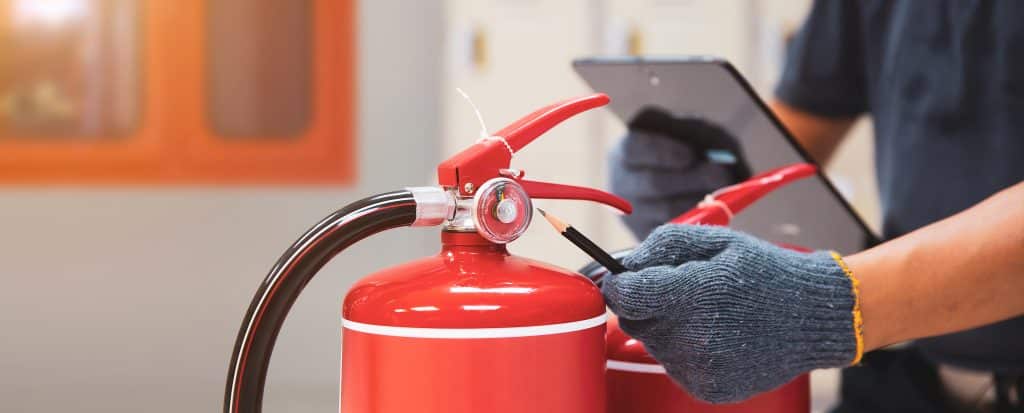 Fire extinguisher, Engineer inspection checking pressure gauge level fire extinguisher tank with fire hose cabinet of protection and prevent emergency and safety rescue and fire alarm system training.