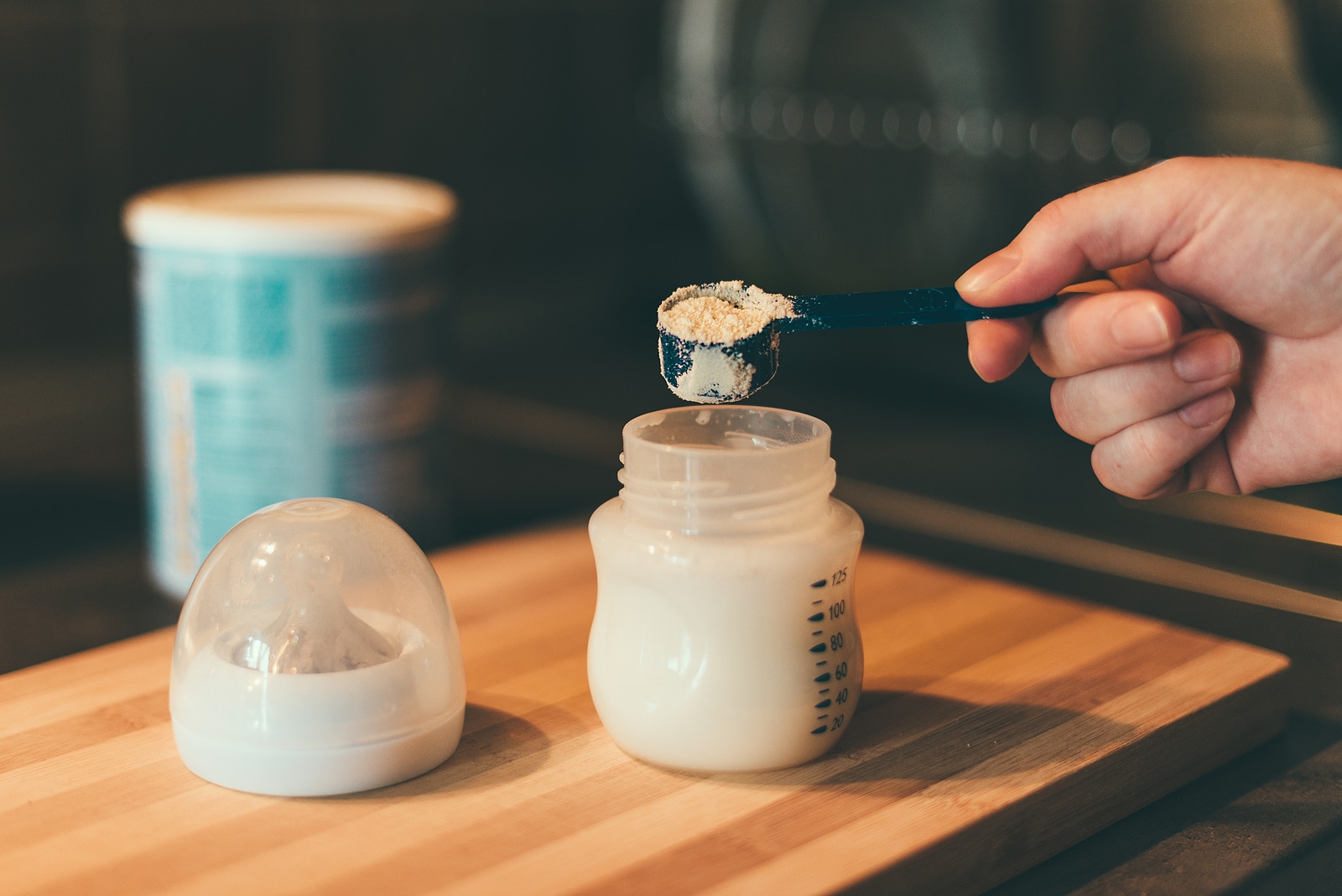 Mother Making Baby Formula In Milk Bottle For A Newborn Baby Fee