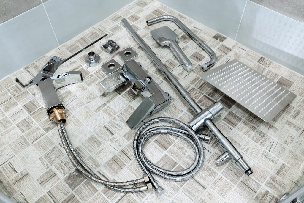Plumbing accessories in the bathroom. Water faucet, hoses, shower head, water faucet. Items for wall mounting and connection.