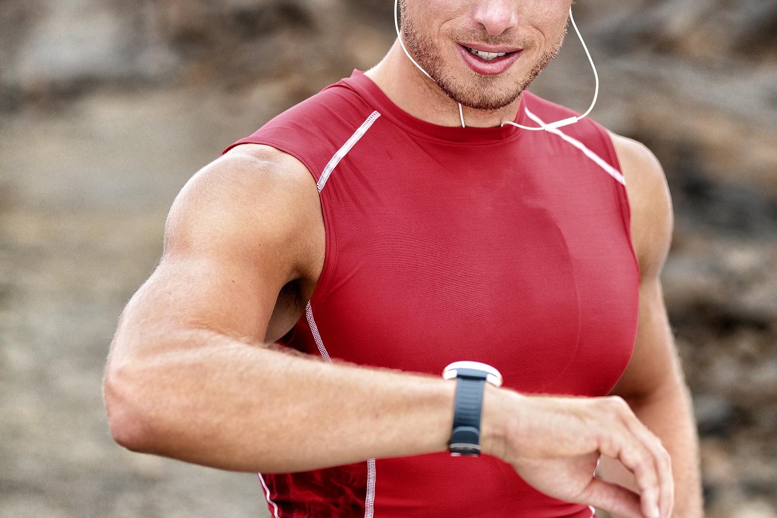 Smartwatch man athlete runner checking his wearable device tech