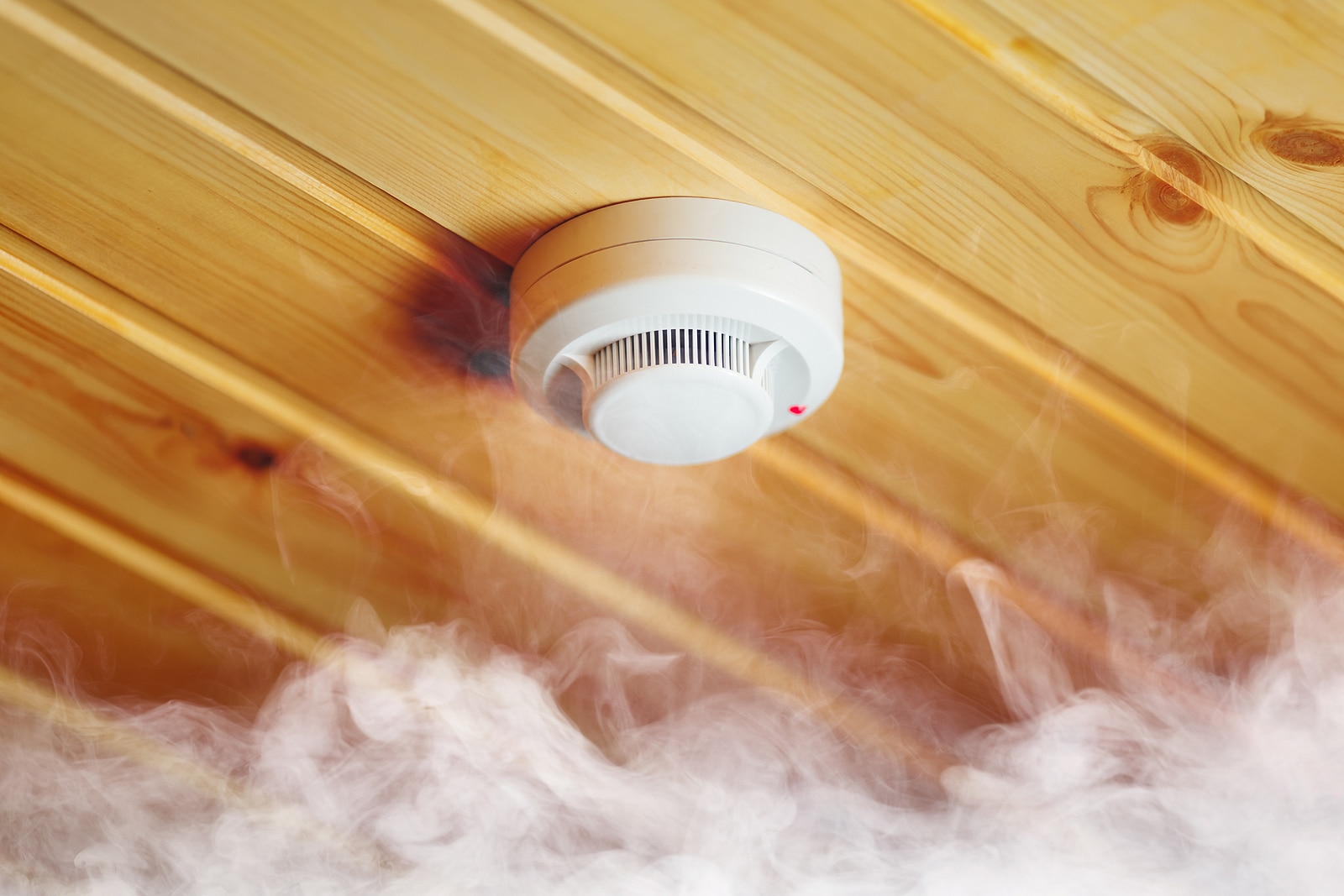 smoke detector in wooden house fire alarm in action