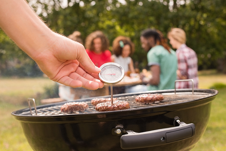 Man using meat thermometer 