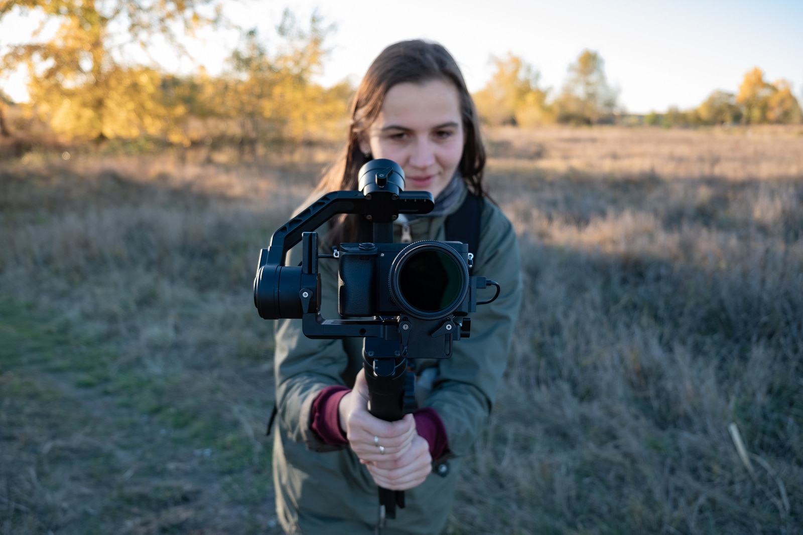 Female Videographer Holding A Gimbal With Mirrorless Camera Wom