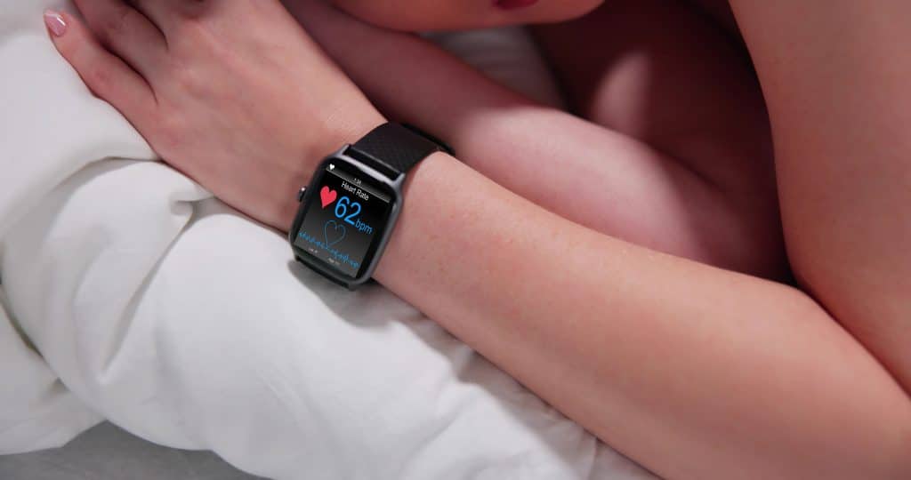 Fitness Activity Tracker With Heartbeat Rate On Woman's Hand