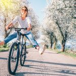 Happy Smiling Woman Cheerfully Spreads Legs On Bicycle On The Co - Savvy Home Guide